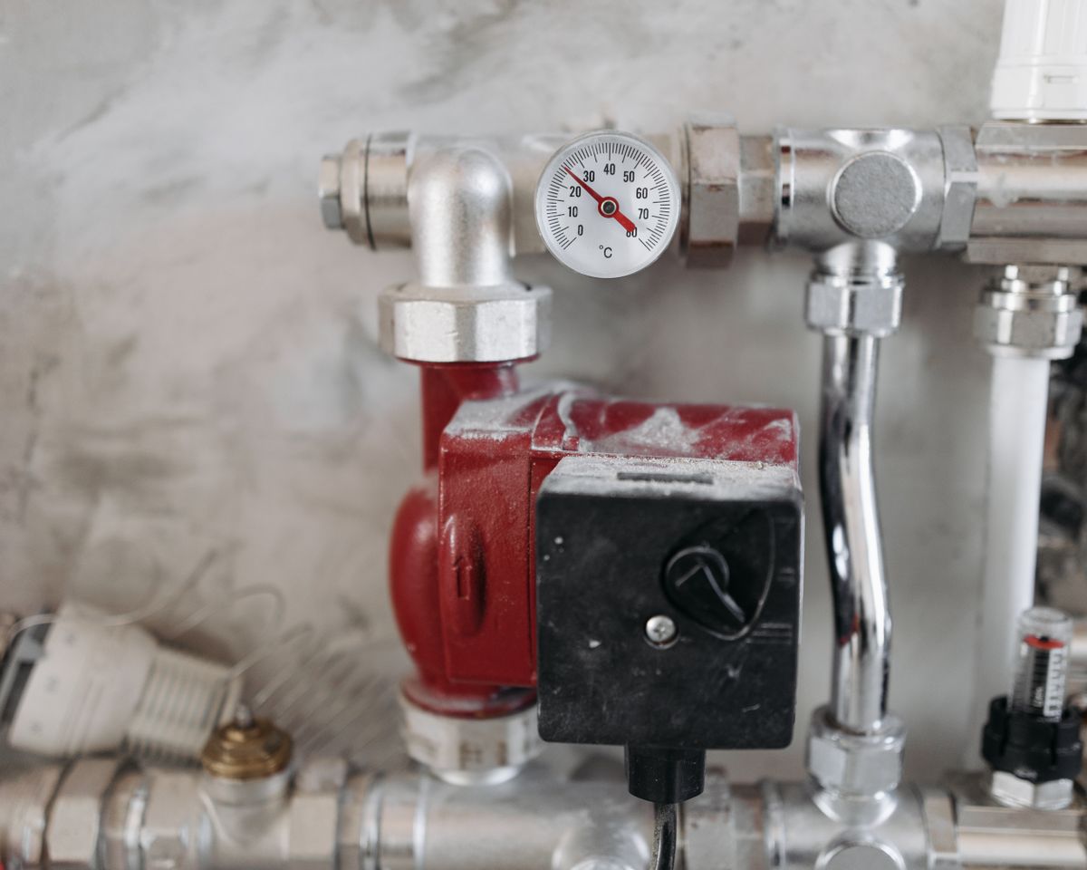 Plumbing pipes with a pressure gauge.