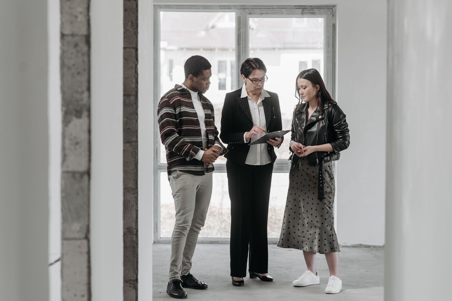 Asesora revisando una propiedad directamente con sus clientes