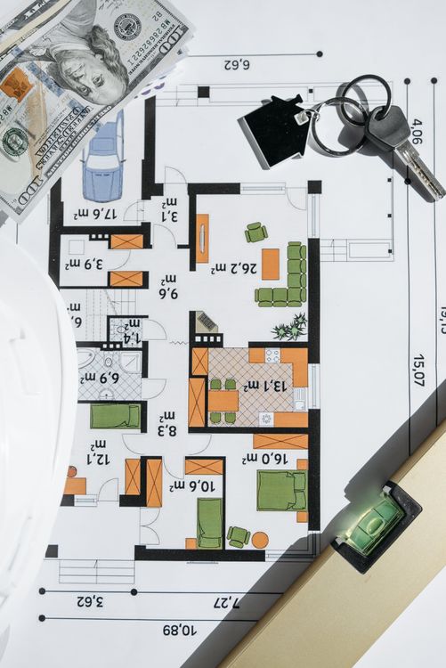 Cash bills and a house key rest on architectural blueprints, representing the equity milestone needed to cancel private mortgage insurance.