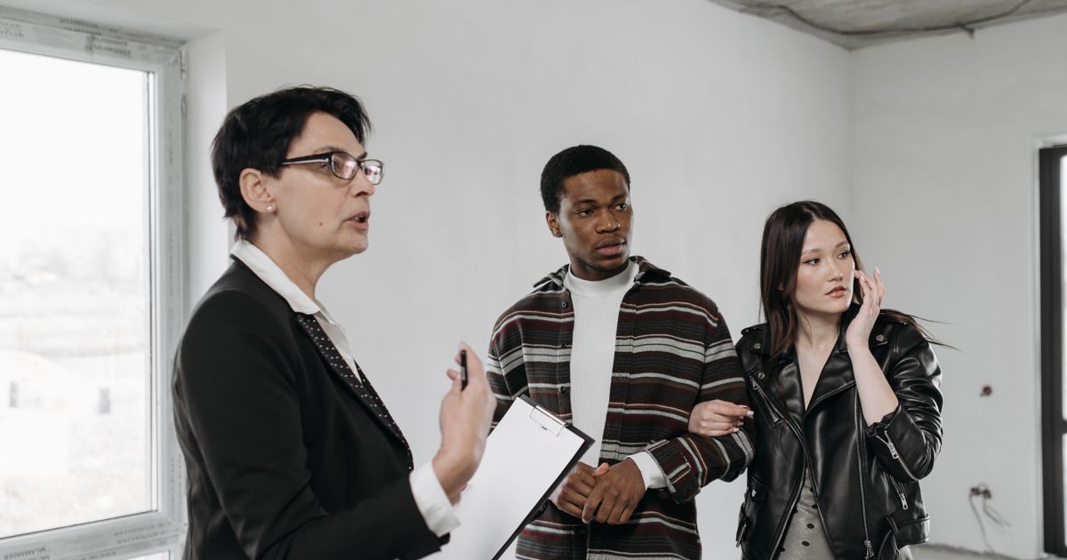 A real estate agent showing a home interior to a couple during a Maryland home tour