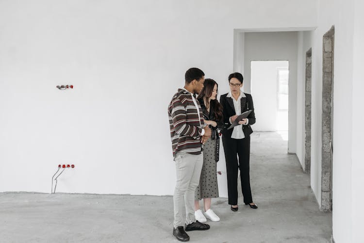 Couple Looking At Real Estate Agent Documents