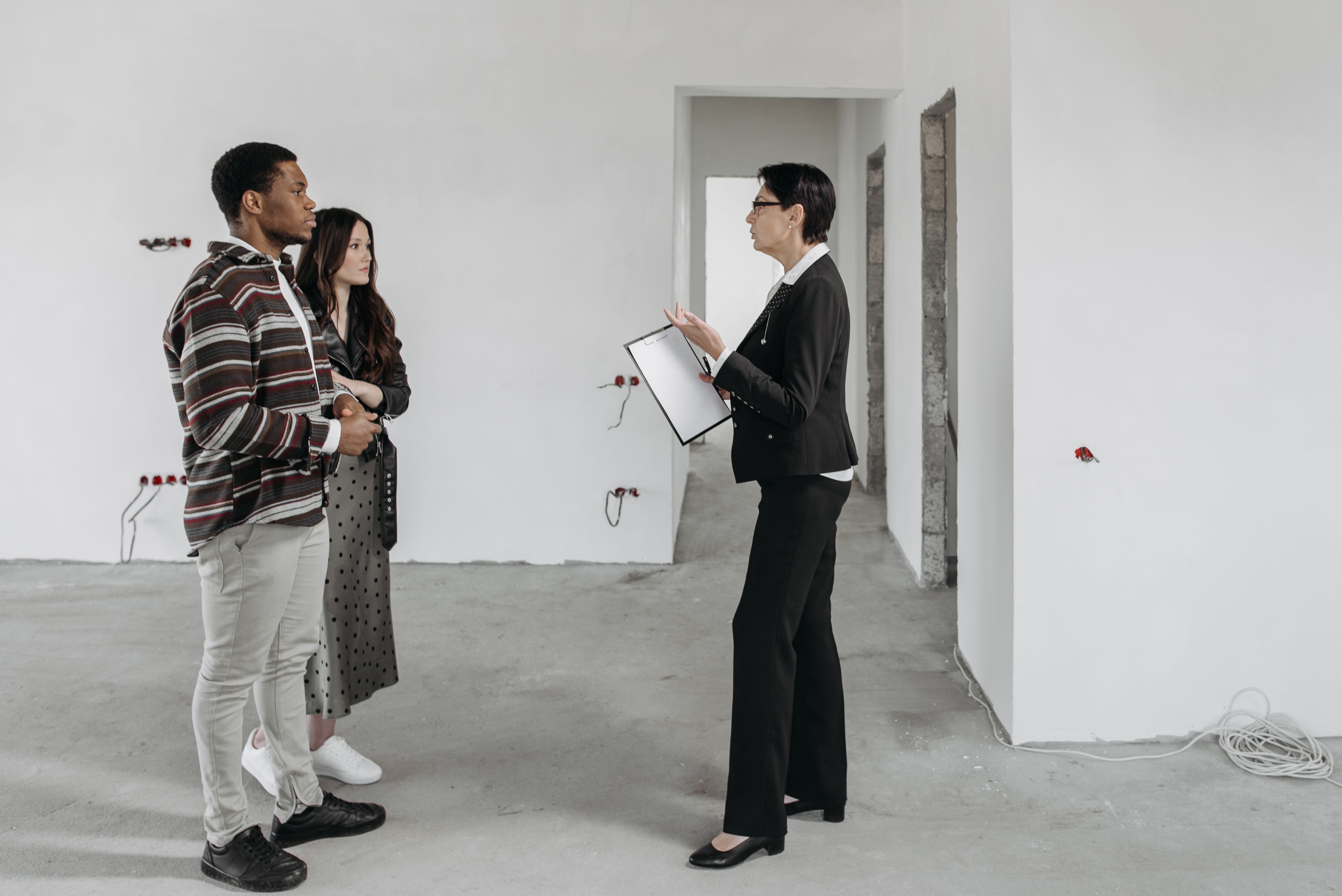 A real estate agent showing clients a home