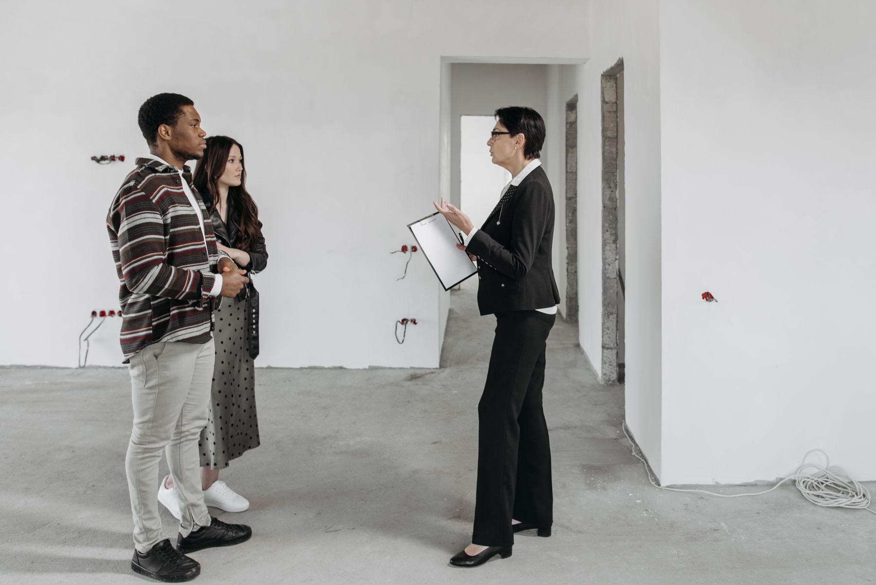 A property professional speaking with clients inside a home