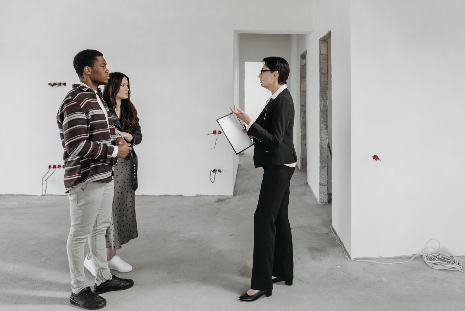 Seller Speaking to Clients in House Room