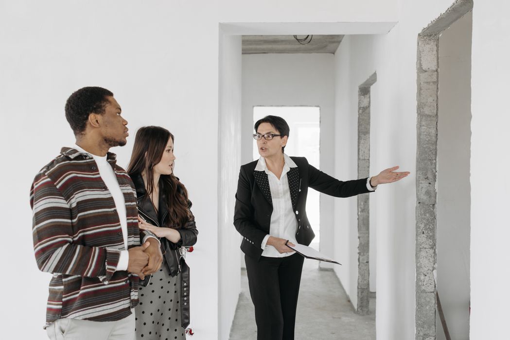 Real estate agent showing a property to a couple
