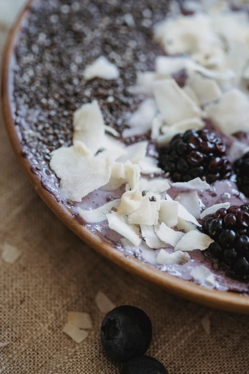 Free Close-up of a breakfast bowl with blackberries, blueberries, chia, and coconut shavings. Stock Photo