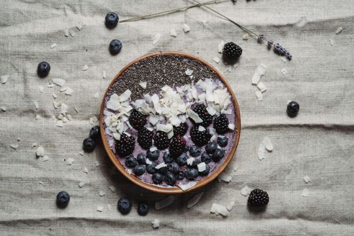 Free A nutritious berry smoothie bowl topped with chia seeds, blackberries, blueberries, and coconut flakes. Stock Photo