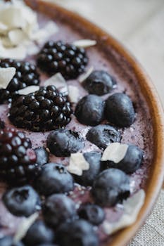 Close-up of a fresh berry and yogurt bowl with blueberries and blackberries.