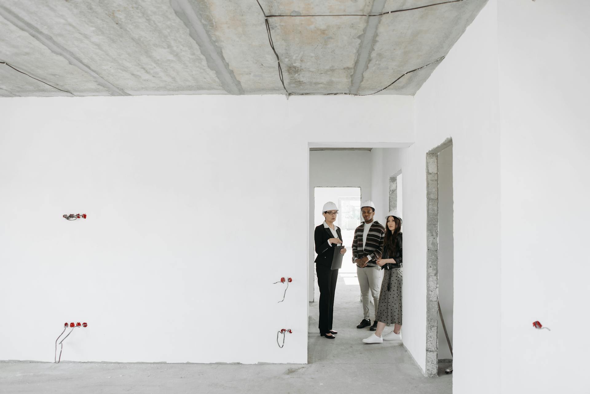 Group of diverse professionals discussing building plans on site.