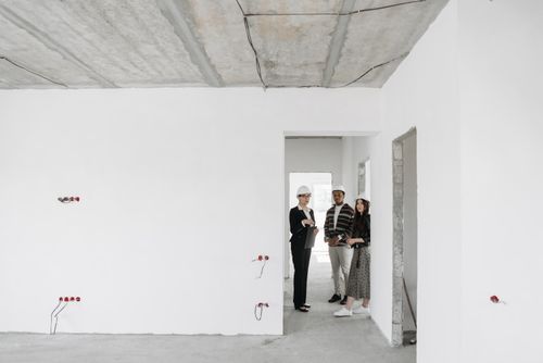 Free Group of diverse professionals discussing building plans on site. Stock Photo