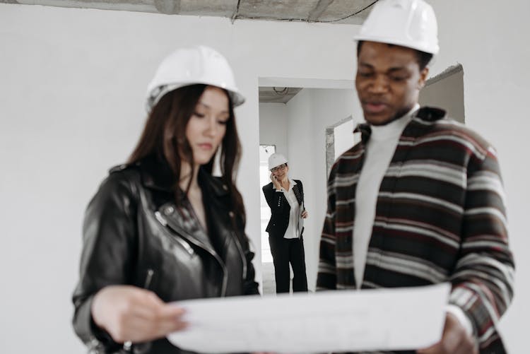 Man And Woman Looking At The Document