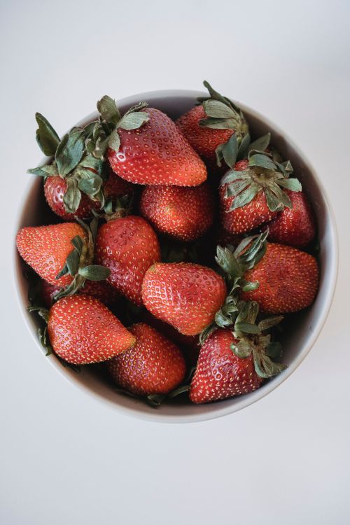 Free Top view of fresh strawberries in a white bowl, perfect for your healthy eating themes. Stock Photo