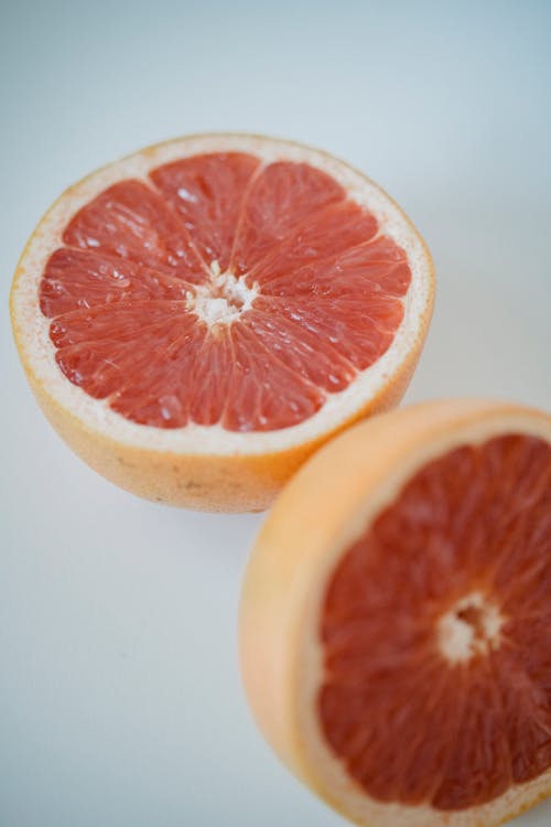 Sliced Grapefruit on White Surface