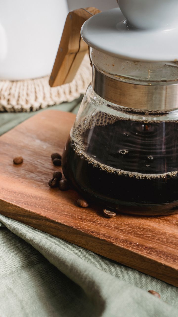 Hand-thrown terracotta ceramic pour-over coffee set displayed on a boho coffee bar counter