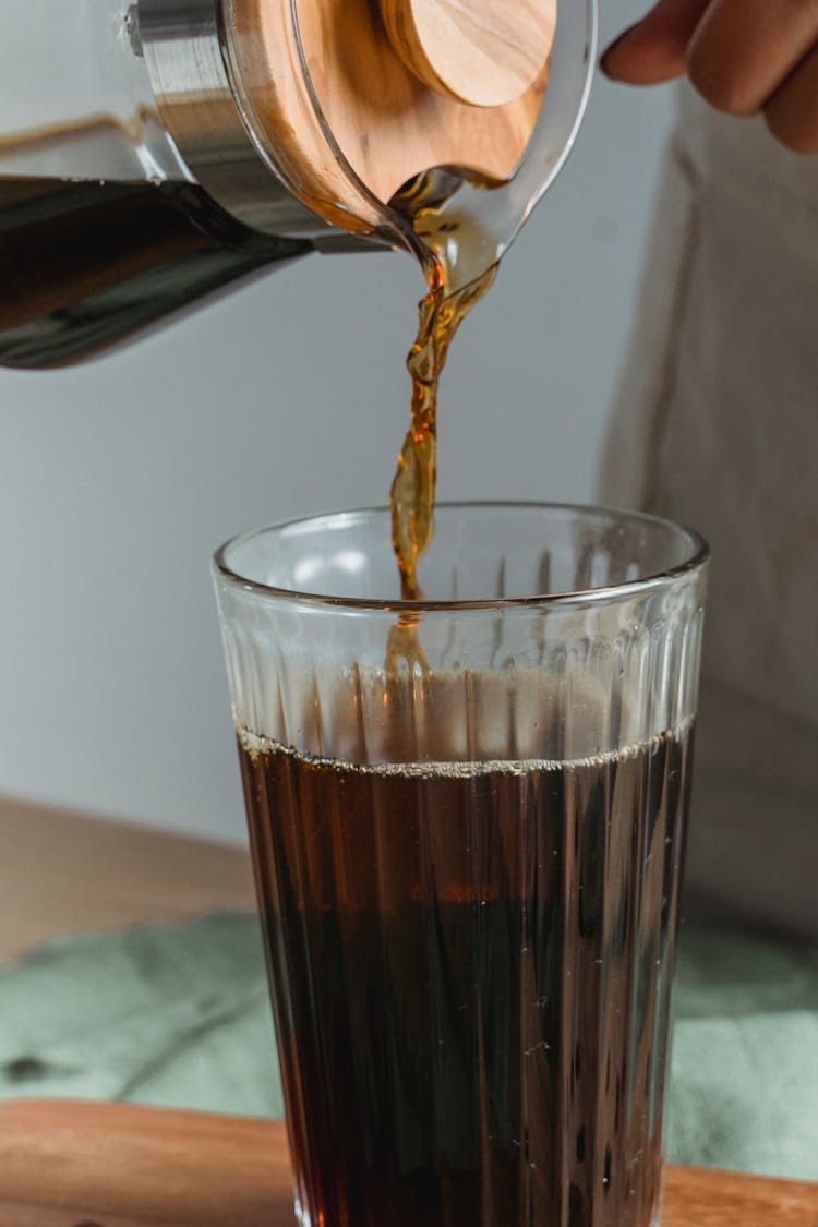 Pouring Coffee Into Tall Glass