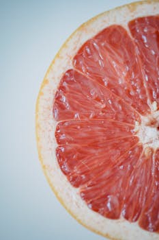 Close-up of a juicy grapefruit slice showcasing vibrant pulp and texture.