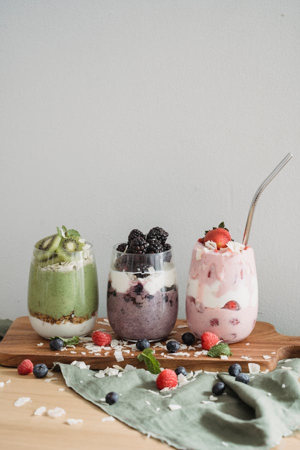 Assorted Fruit Shakes with Fresh Fruits in Clear Glasses