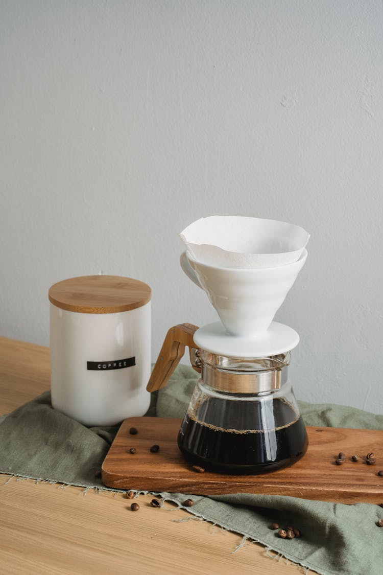 White Ceramic Cup On Top Of Clear Glass Teapot