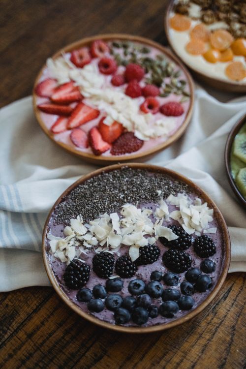 Free Colorful bowls of fresh fruit and seeds, perfect for a healthy breakfast. Stock Photo
