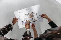 Couple Holding Blueprint of a House