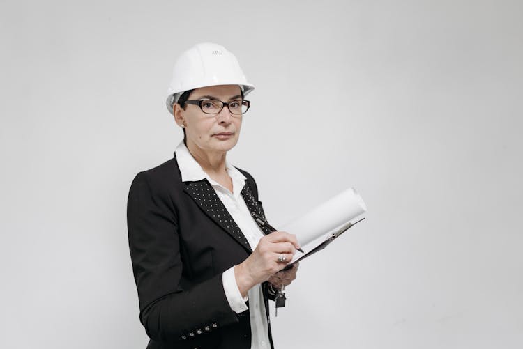 A Female Realtor Standing Against White Background