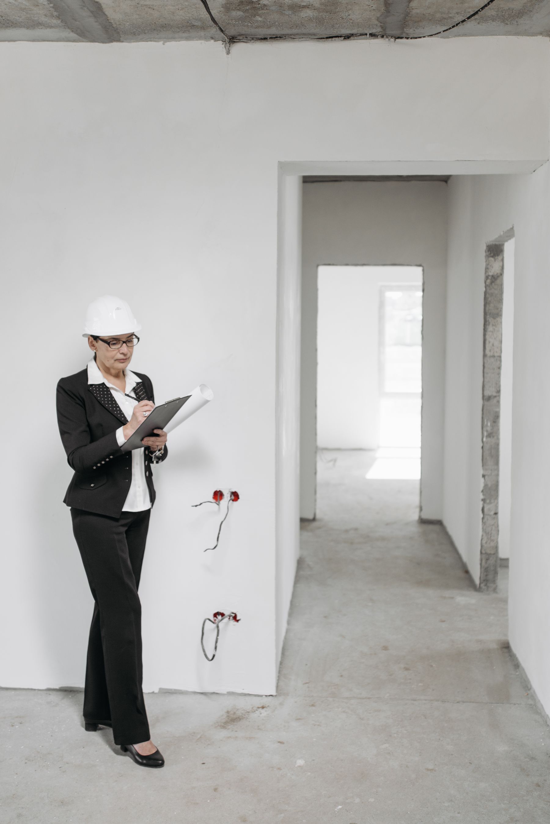 Building inspection professional carrying out a property assessment with a clipboard