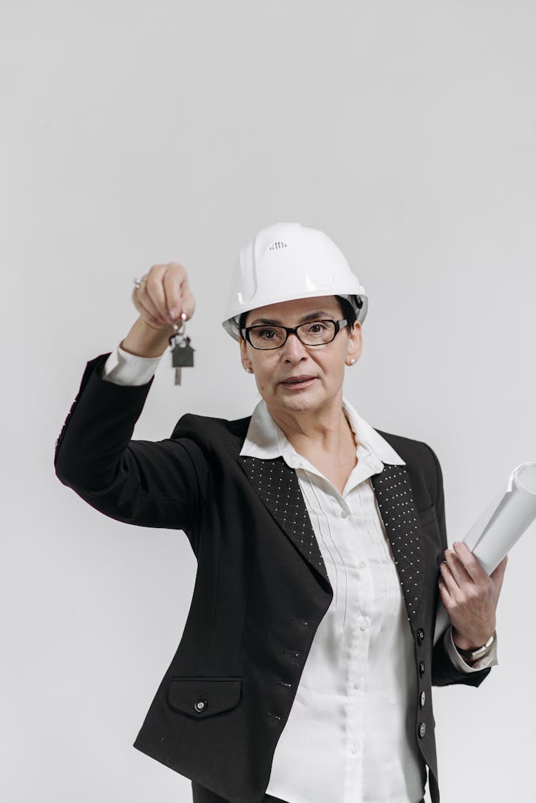 A Female Realtor Holding A Key