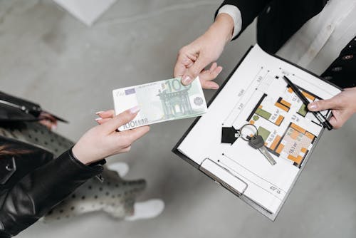 Free A Client Handing Payment to a Realtor Stock Photo