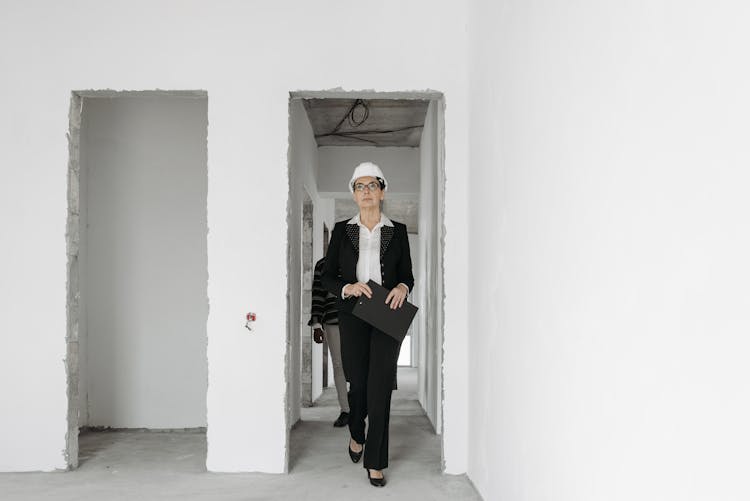 A Woman In Black Blazer Walking At The Doorway