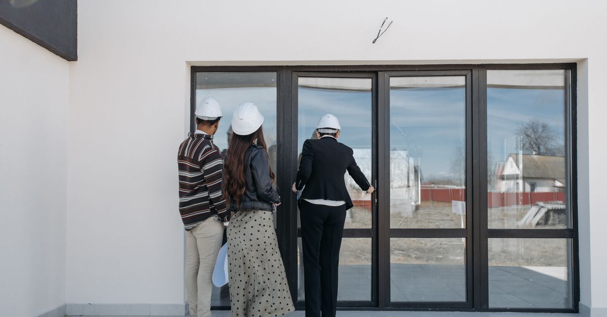 Estate agents showing a new home to clients