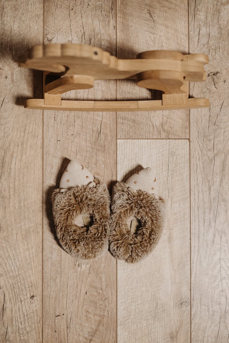 Fluffy Slippers And A Wooden Rocking Horse