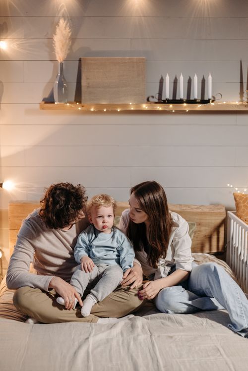 Free A family enjoying a warm and cozy moment together in their bedroom. Stock Photo