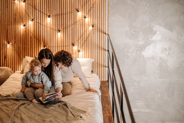 Family Sitting On A Bed