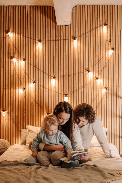 Free A Family Reading a Story to Their Son Stock Photo