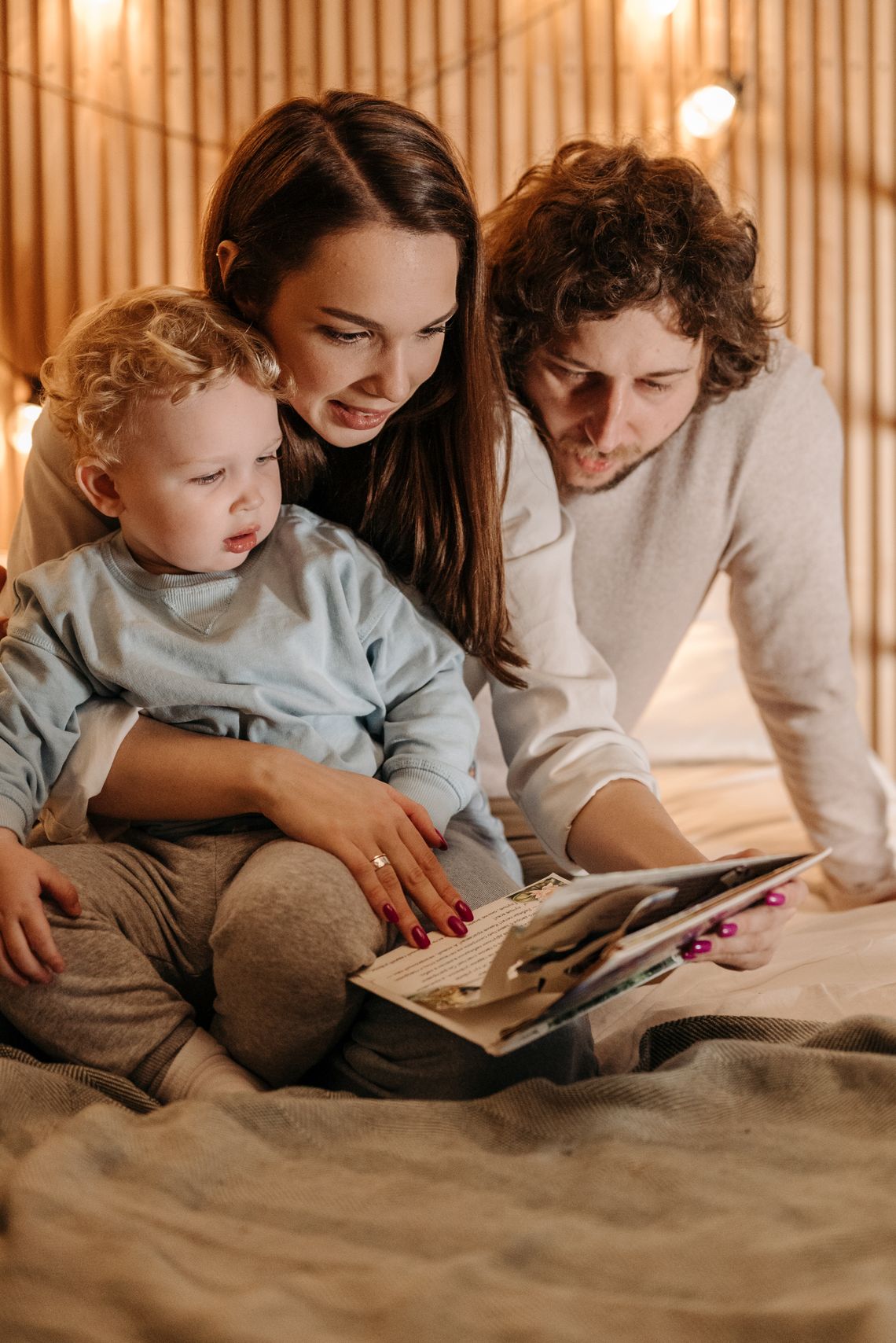 Family reading a book together during a warm learning moment at home