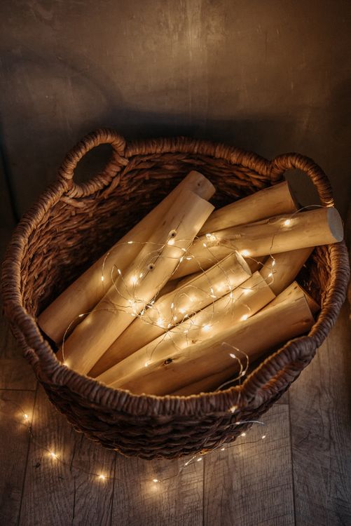 Basket filled with wood and twinkling fairy lights
