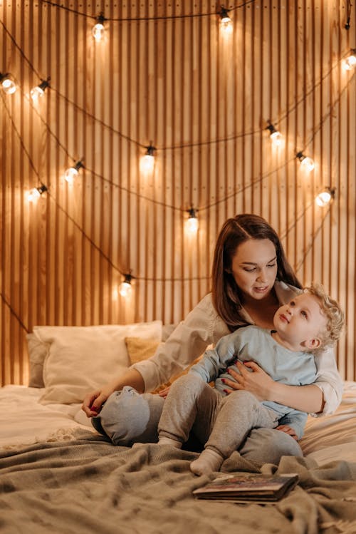 Free Mom and Son Sitting on the Bed Stock Photo