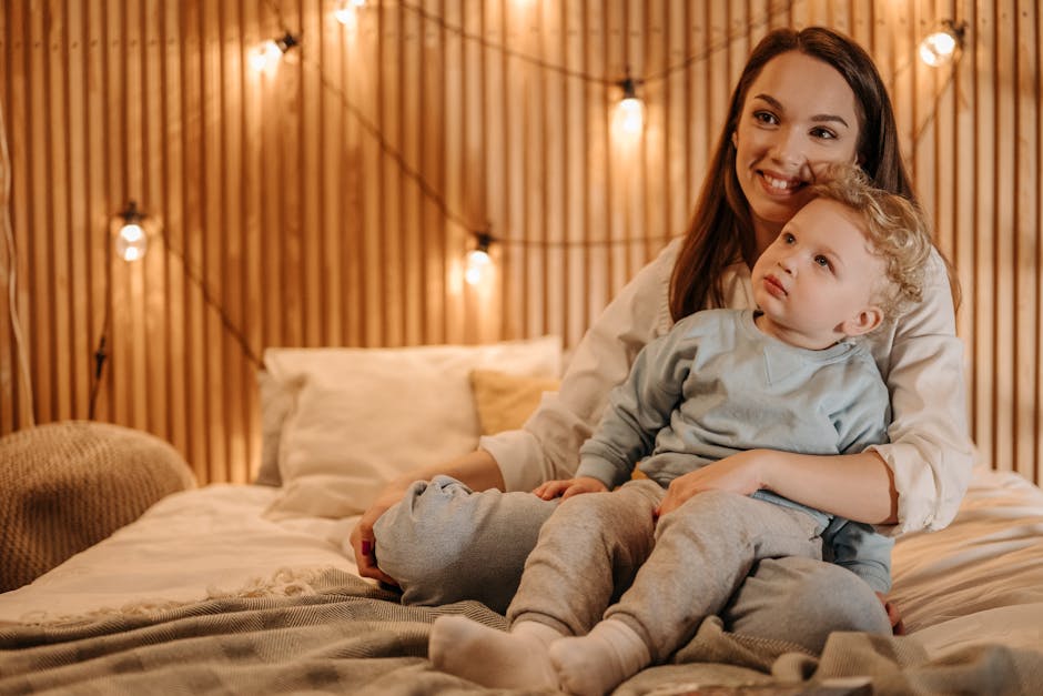 Warm intimate moment of a mother and child bonding in a cozy bedroom setting.