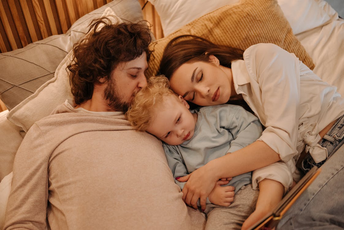 Free Family Lying on Bed
 Stock Photo