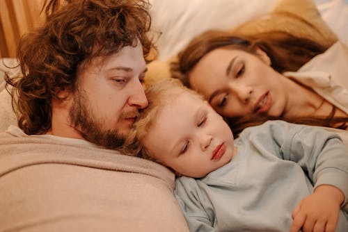 Free Close-Up Shot of a Family Lying Down Stock Photo