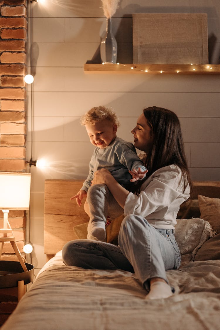 A Mother And Son On The Bed 