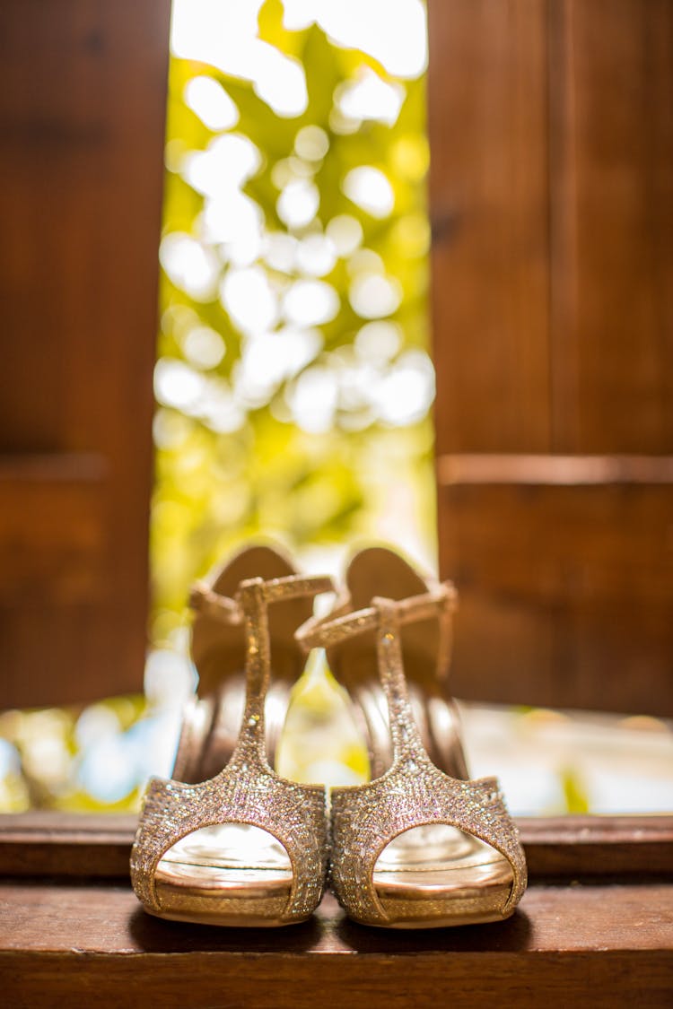 Gold High Heels On A Wooden Surface