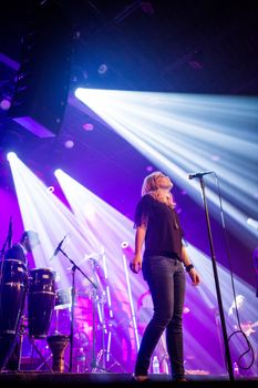 Energetic live performance with vibrant lighting at a music venue.