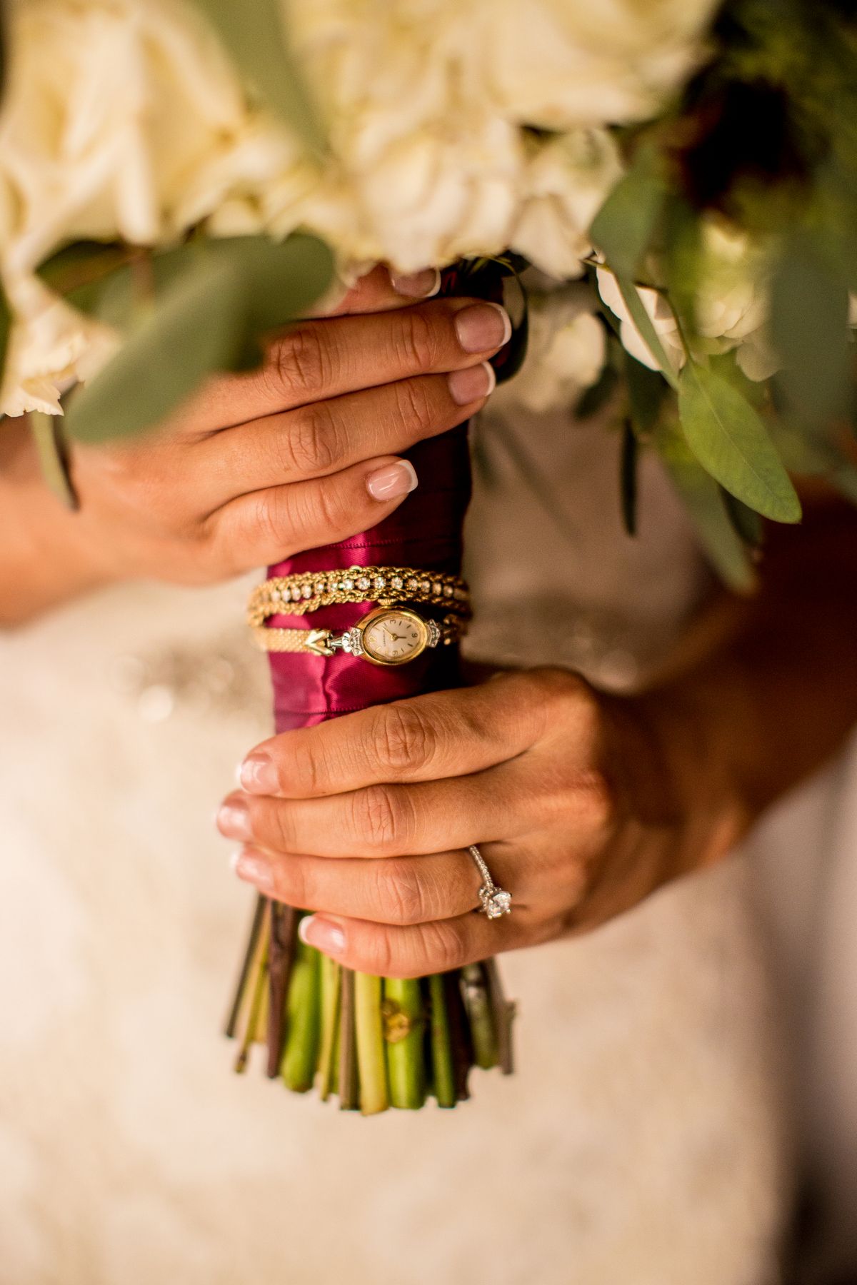 Bride holding bouquet, close-up of hands