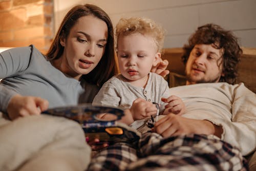 Mother Reading Book to a Toddler