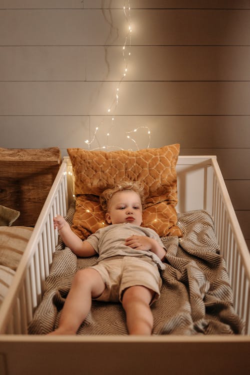 Free A Young Boy Lying on the Crib Stock Photo