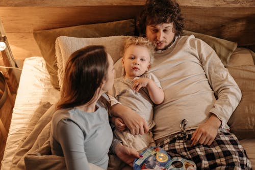Free Photo of a Family Relaxing in Bed Stock Photo