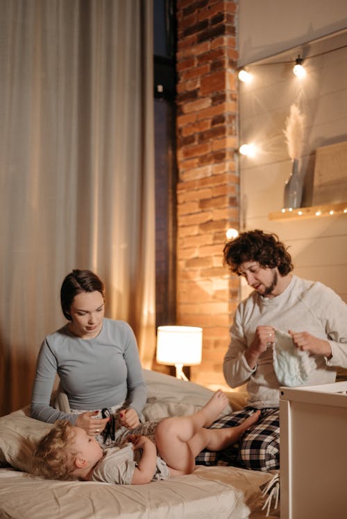 Free Father changing Diaper of a Baby Stock Photo