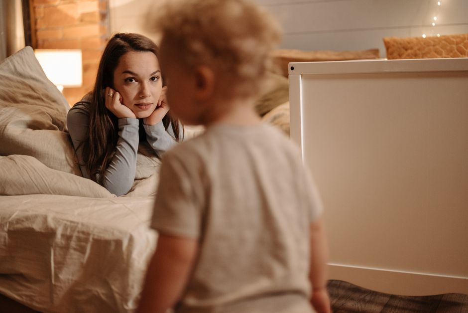 mother and child inside cozy bedroom decorated rustic style