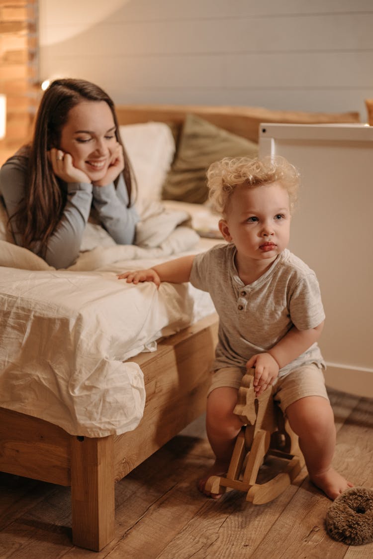 Toddler Sitting On Rocking Horse